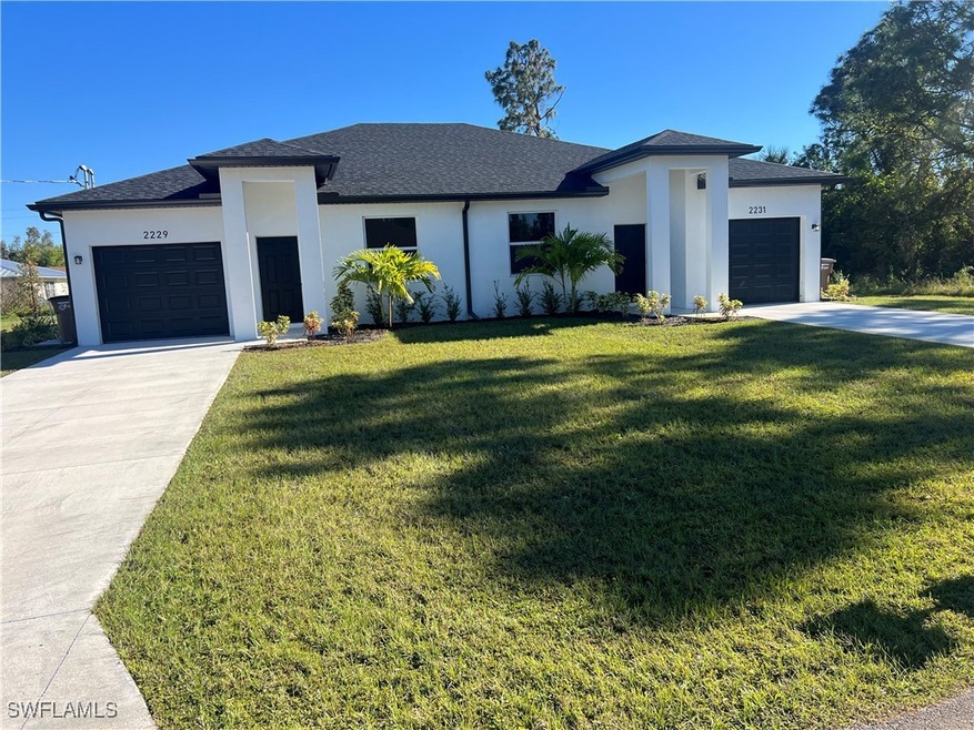 Prairie-style house with a front yard and a garage
