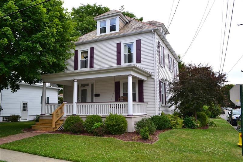Front of home with large front porch and swing