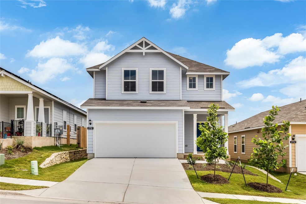 View of front of house featuring a garage, drivew