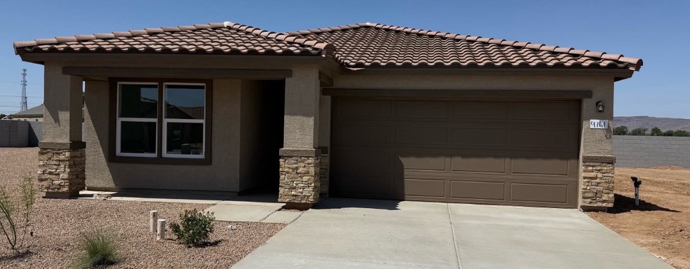 View of front facade featuring stucco siding, driv
