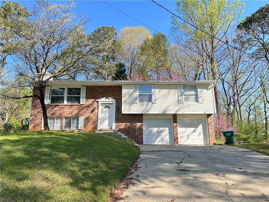 Raised ranch with a front yard and a garage