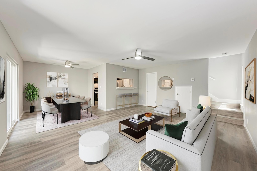 Living area with a ceiling fan, light wood-style 