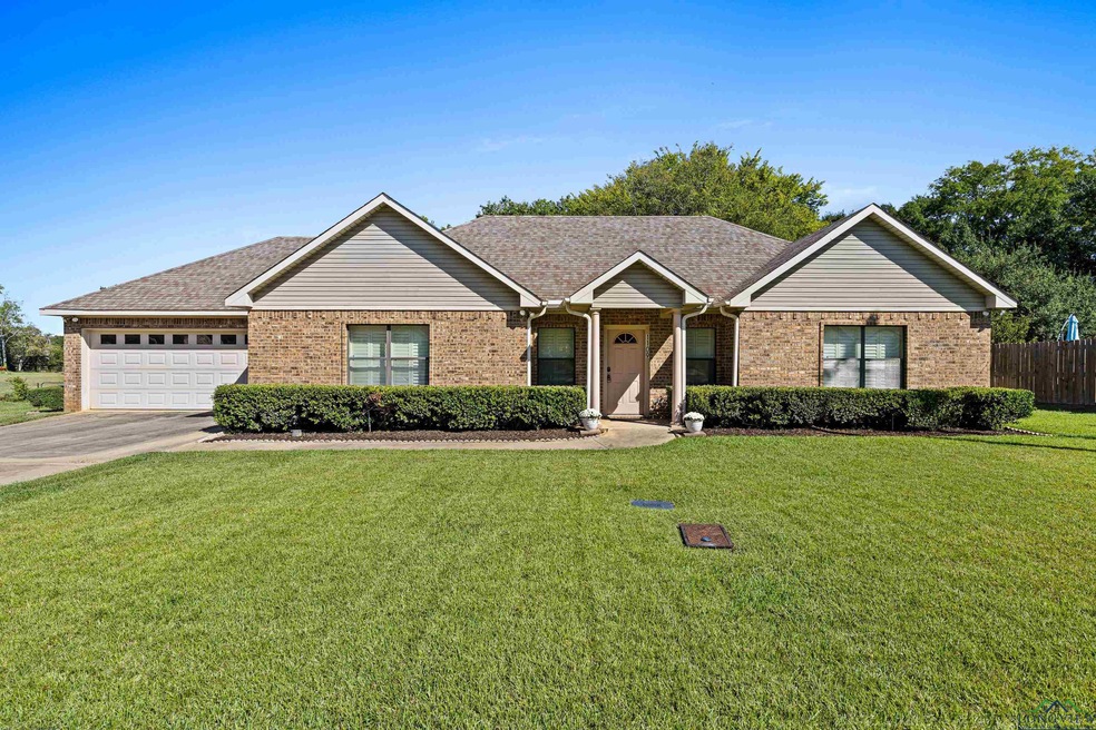 Ranch-style home featuring a front lawn and a gara