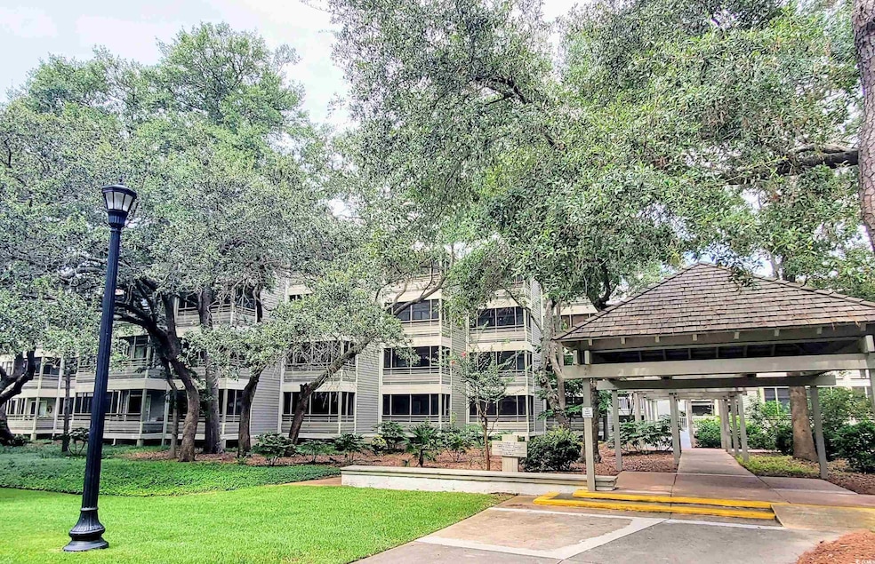 View of property featuring uncovered parking