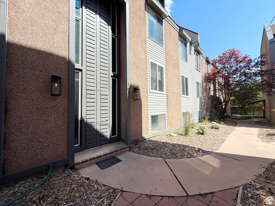 Doorway to property with stucco siding