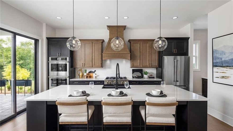 Kitchen featuring appliances with stainless steel finishes, abundance of natural light, light countertops, backsplash, and recessed lighting. Photos are of the Tallulah Model Home and are not representative of actual home. Designer features may vary.