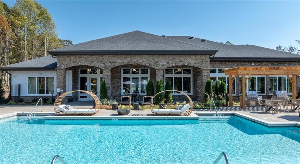 Community pool featuring a patio and an outdoor structure