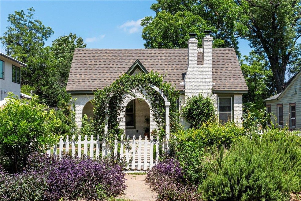 English style home with roof with shingles, brick