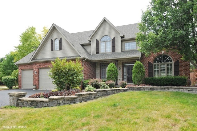 FRONT OF HOME BRICK AND STONE EXTERIOR WITH UPGRAD