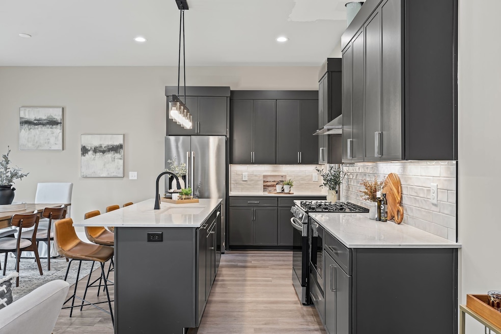Junipers Beautiful Open Kitchen Floor Plan with Designer Fixtures: Quartz Countertops & Custom Cabinets.