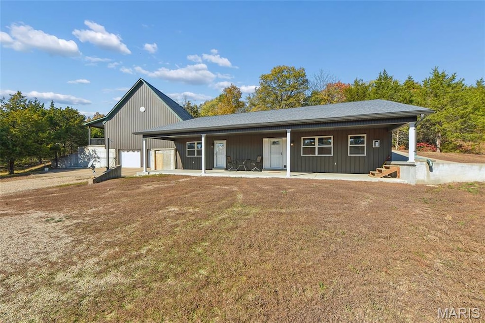 View of front of home with a porch and a front yard