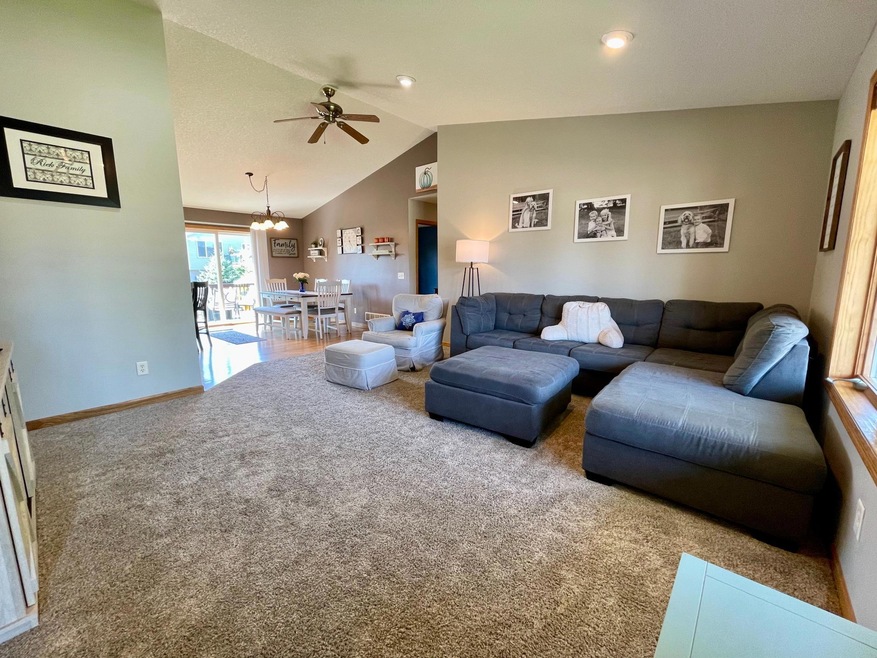 Facing the dining area from the living room. The hallway leading to the main floor bedrooms can also be seen. Note the high ceilings!