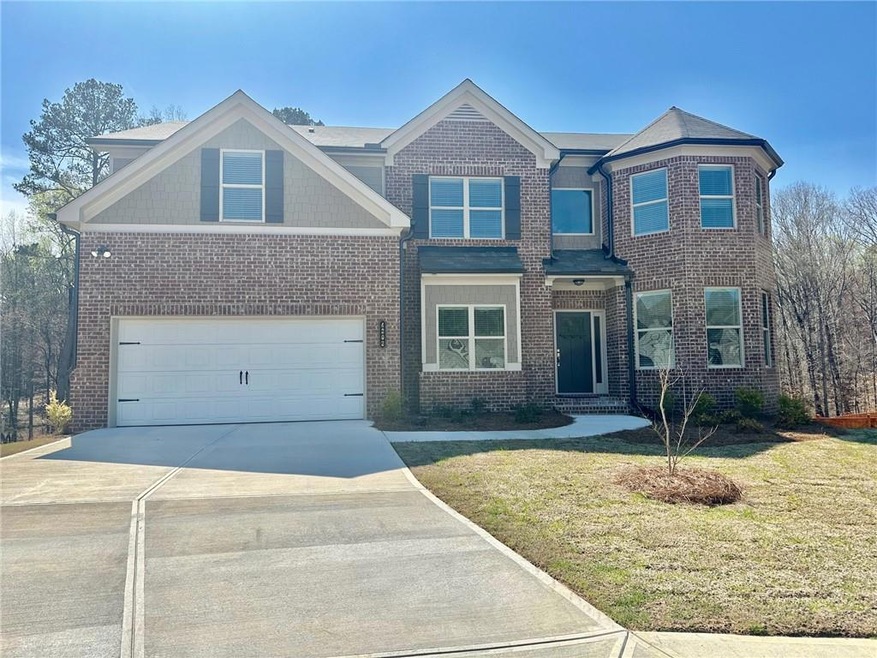 View of front of home with a front lawn and a gara