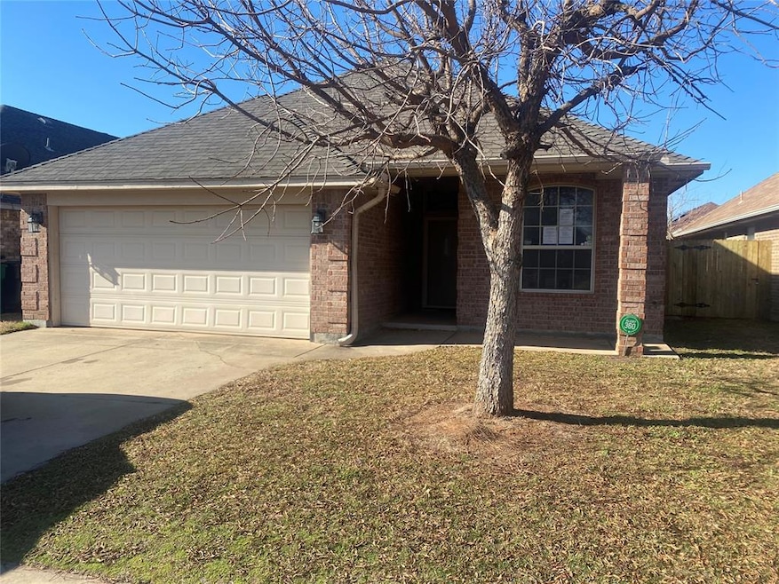 Single story home featuring a garage and a front l