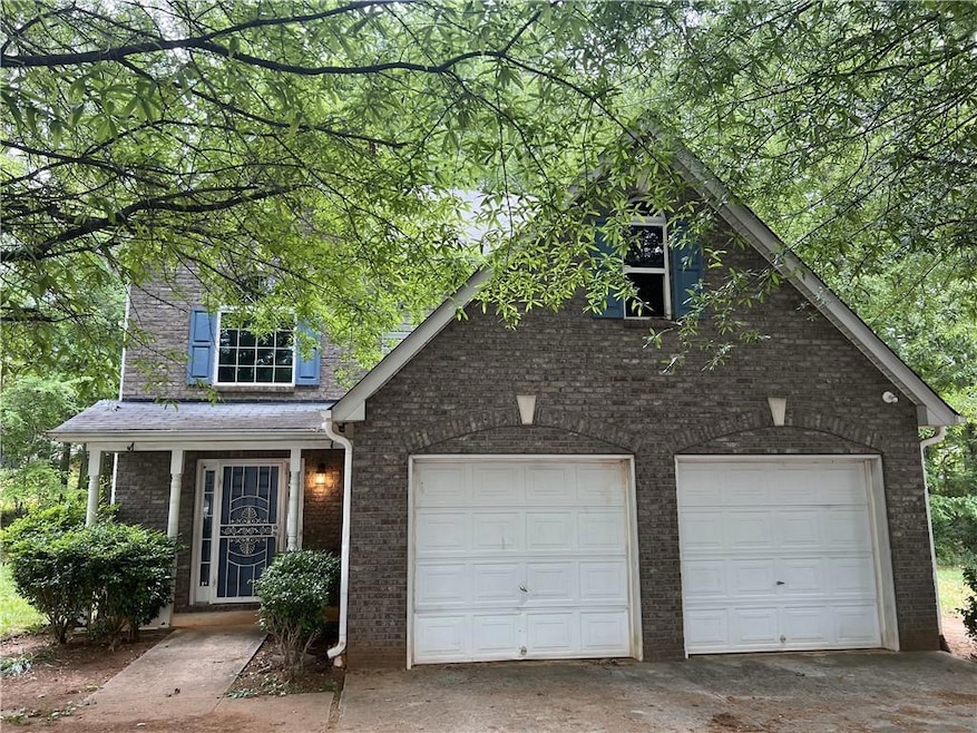 Traditional home with a garage, concrete driveway,