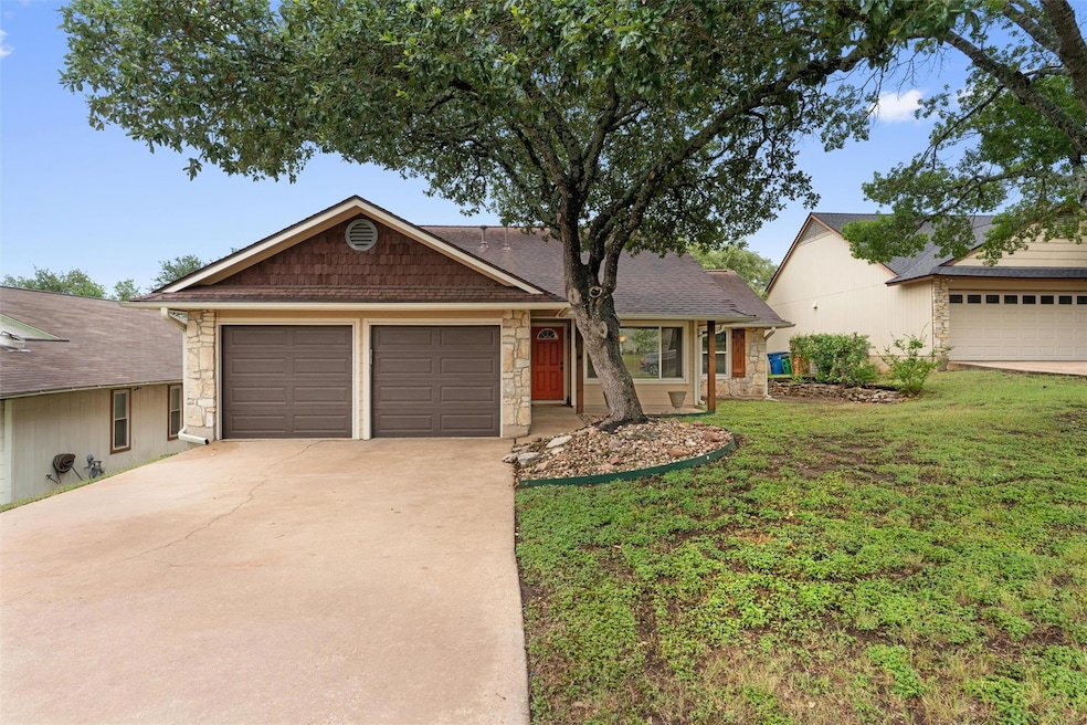Ranch-style house featuring stone siding, drivewa