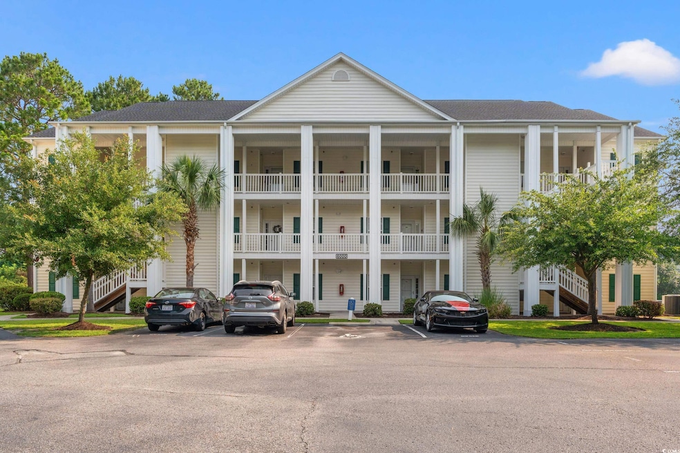 View of property featuring stairway, uncovered parking, and cooling unit