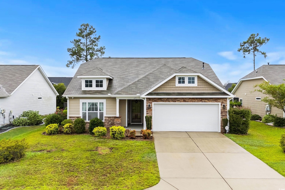 Craftsman inspired home featuring a garage and a f