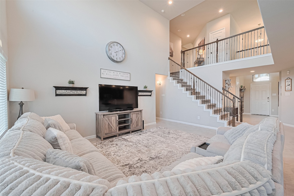 Stunning two-story living room with soaring ceilin