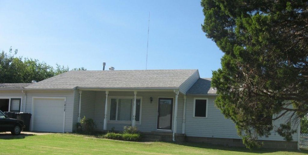Charming home with large yard and mature tree.