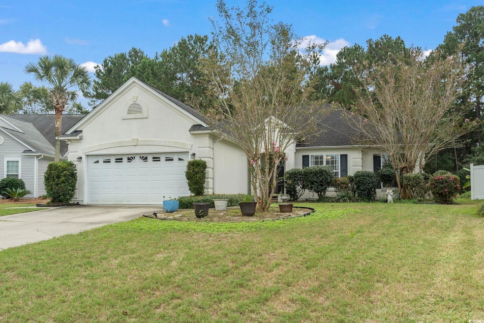 Ranch-style house with a garage and a front lawn