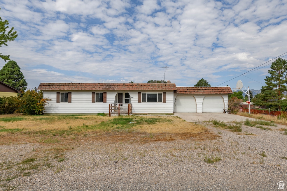 Ranch-style home with driveway and an attached garage