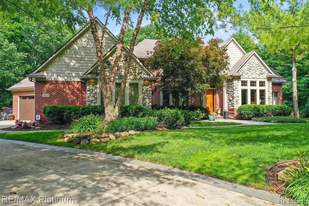 Beautiful home surrounded by trees and greenery.