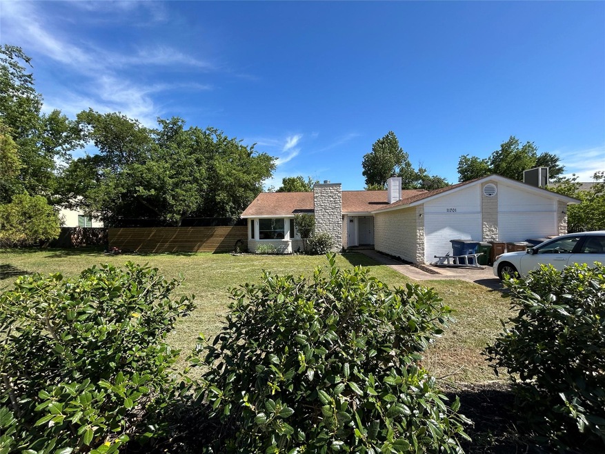 View of front of house featuring a chimney and an