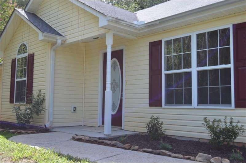 Fresh paint and newly planted landscaping await ne