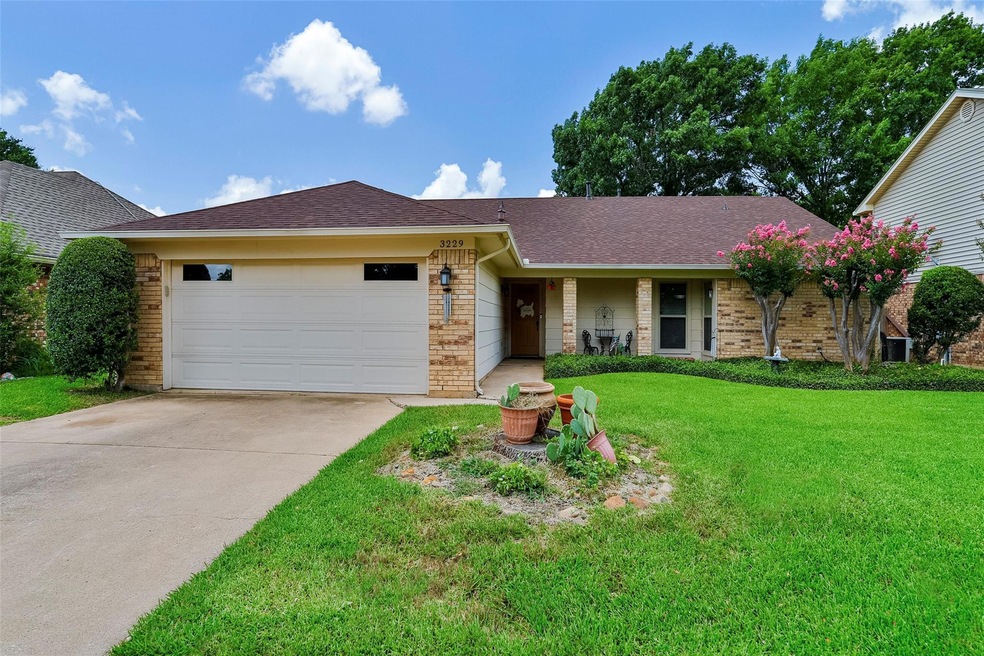 Ranch-style house with a garage and a front yard