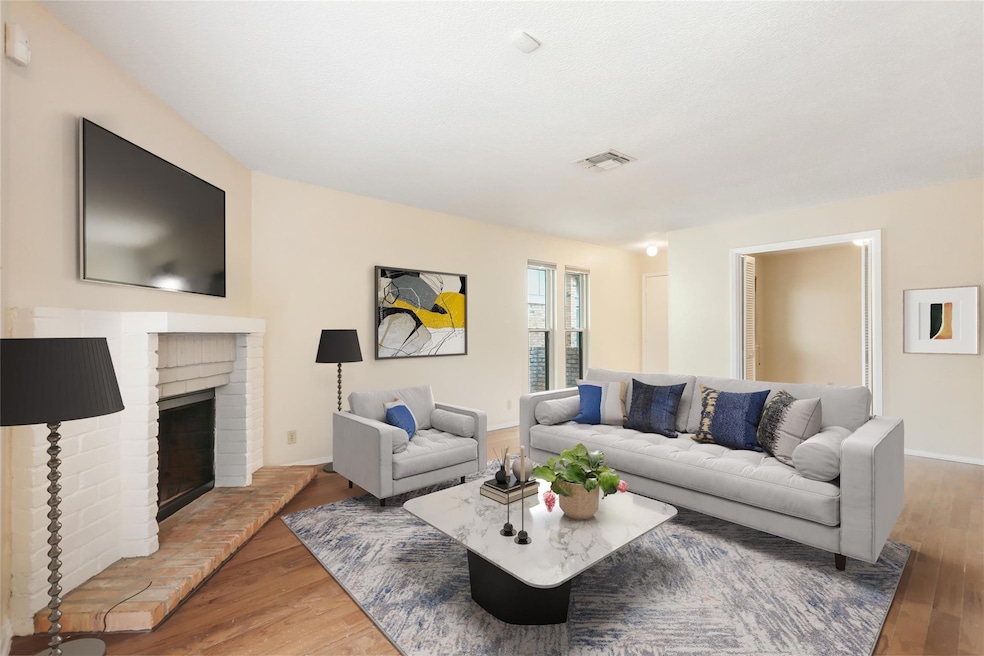 Living area with baseboards, a fireplace, visible