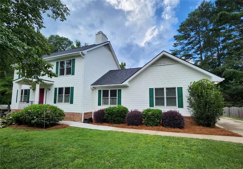 Colonial home with a chimney and roof with shingles