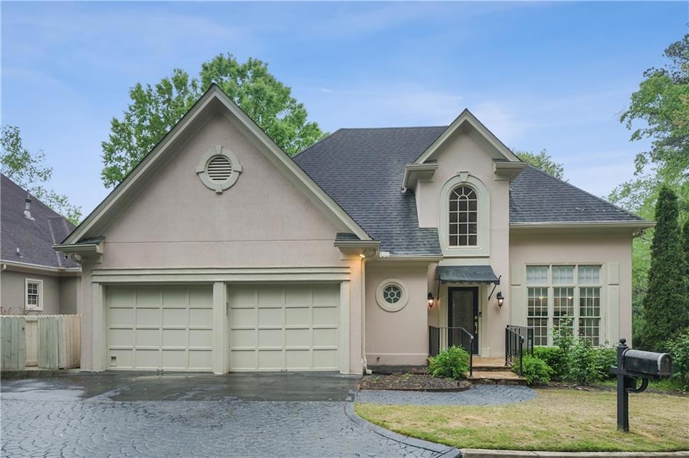 View of front property with a front yard and a gar