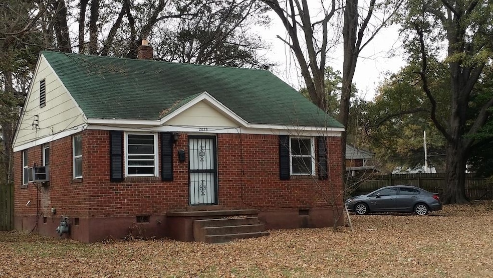View of front of house with crawl space, brick siding, roof with shingles, and a chimney