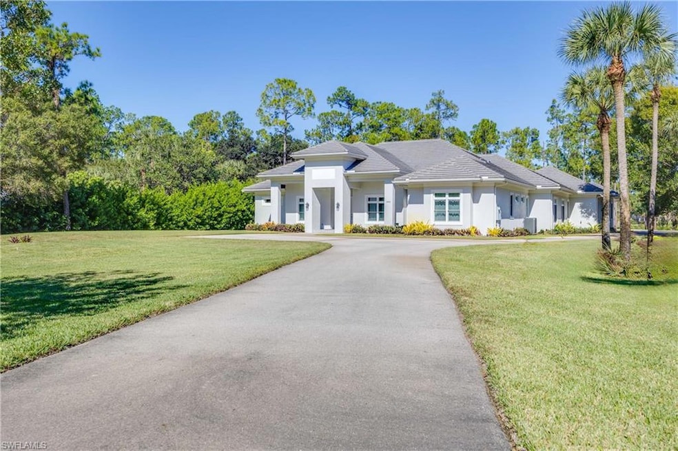 The long driveway leads to a large parking area in the front of the home. Driveway continues to the rear of the house and four car garage with another large parking pad.