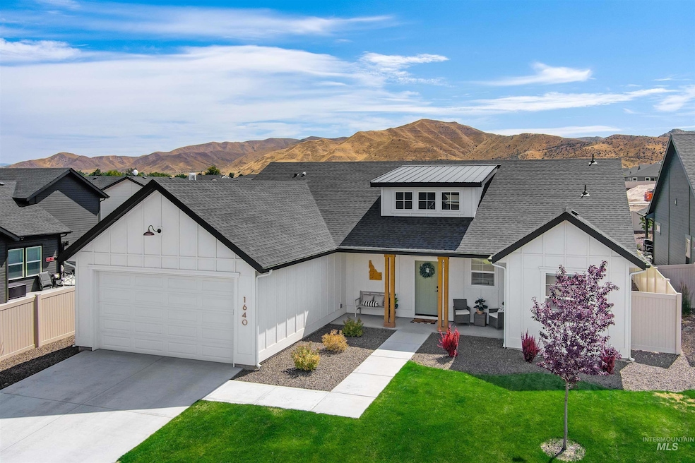 Modern farmhouse with a mountain view, a garage, a shingled roof, covered porch, and concrete driveway