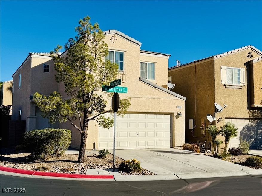 View of front of home featuring stucco siding and driveway