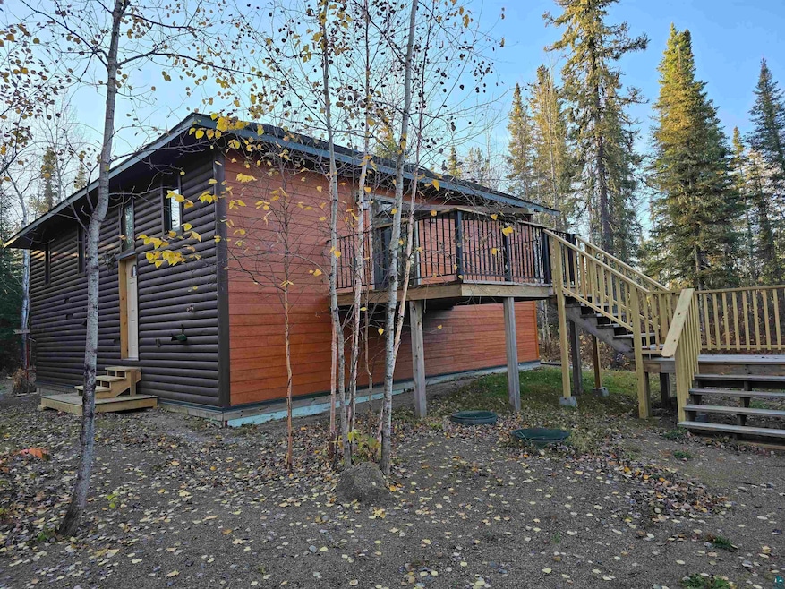 View of side of home featuring a deck