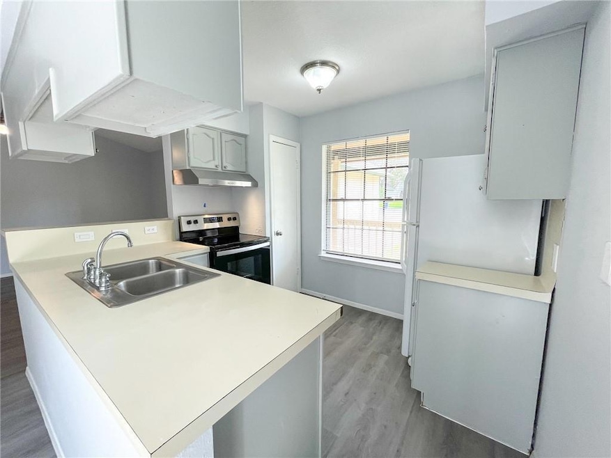 Kitchen with stainless steel range with electric 