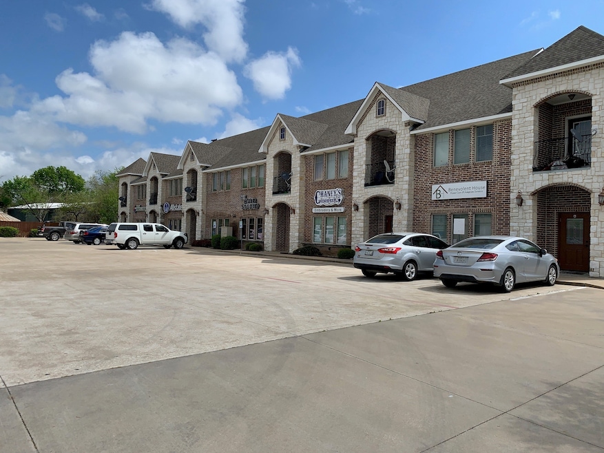 View of property featuring uncovered parking and a residential view