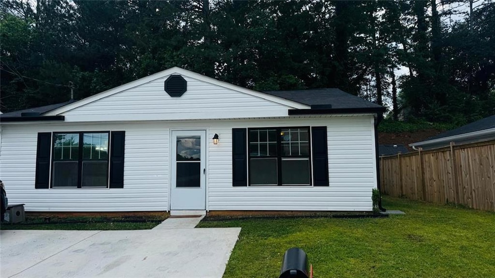 Bungalow-style home with a front lawn and fence