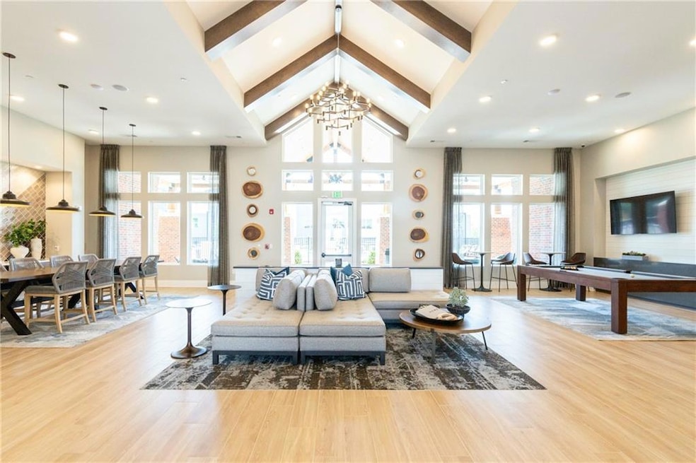 Living room featuring beam ceiling, hardwood / woo