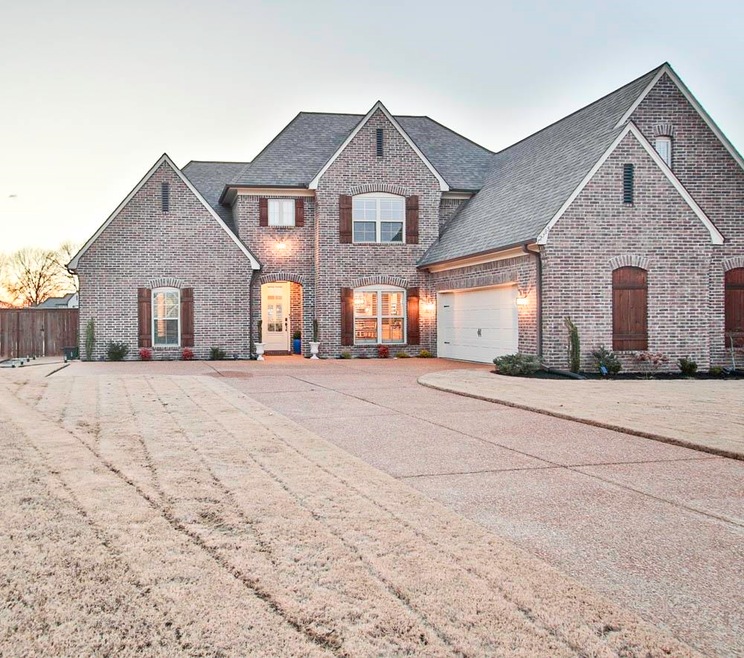 French provincial home with concrete driveway, bri