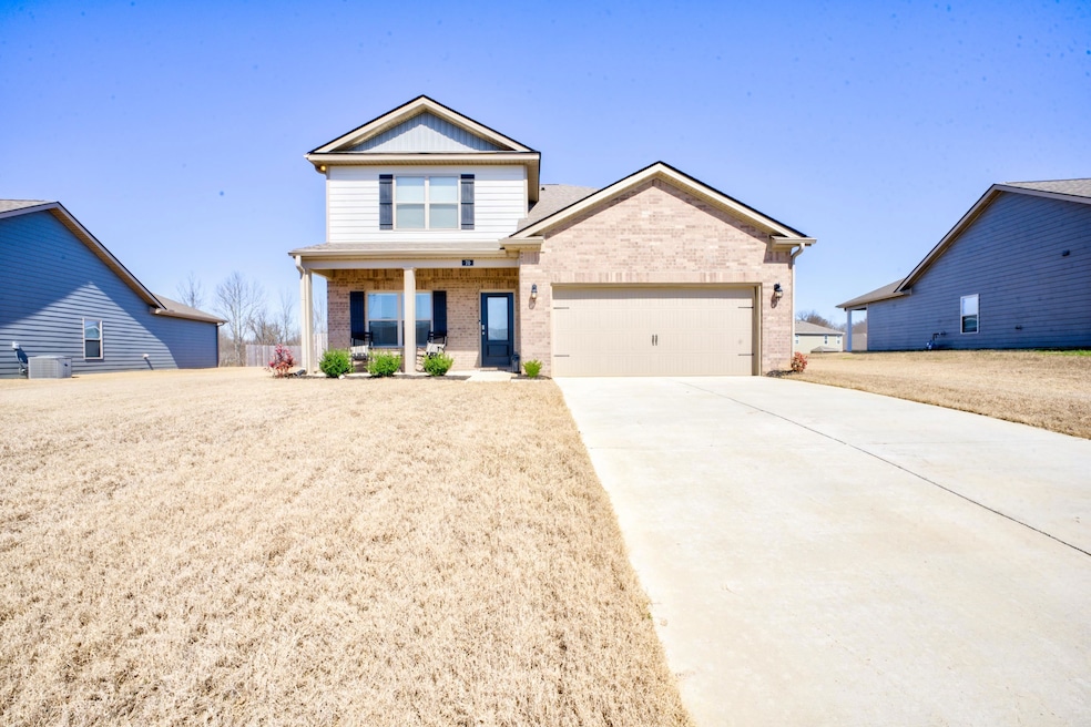 View of front of home with brick siding, a porch, 