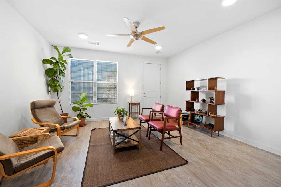 Living area with light wood finished floors, ceiling fan, and recessed lighting