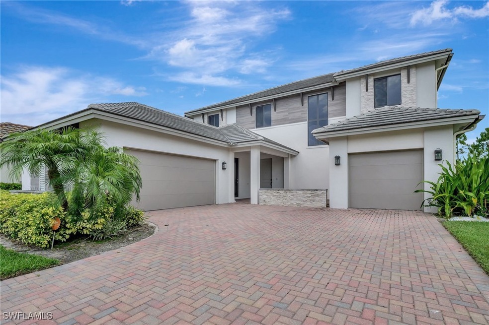 Prairie-style home featuring decorative driveway,
