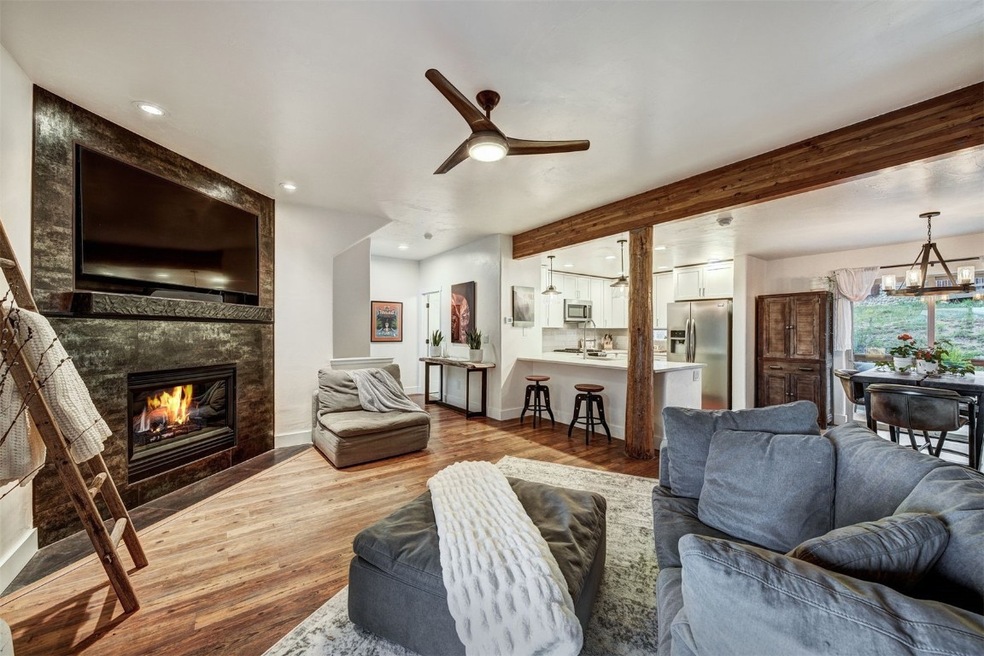 Living area featuring a tile fireplace, a chandeli