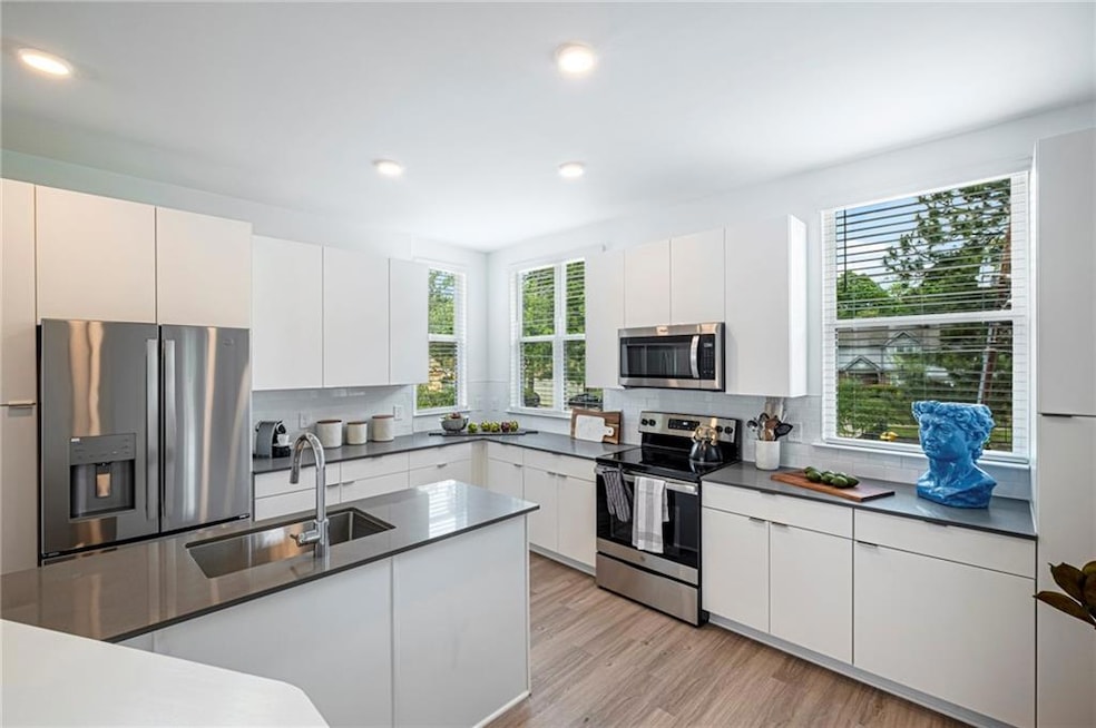Kitchen with white cabinetry, stainless steel appl