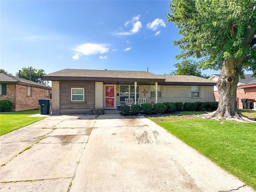 View of front of property featuring brick siding, a front yard, and covered porch