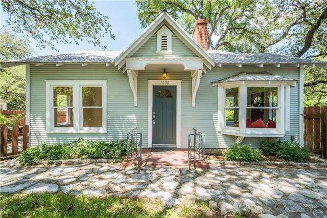 Original front entry to home with privacy fencing 